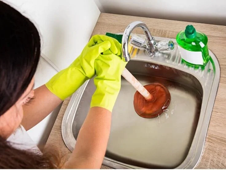 Kitchen Drain Cleaning Plumber cleaning clogged kitchen sink drain