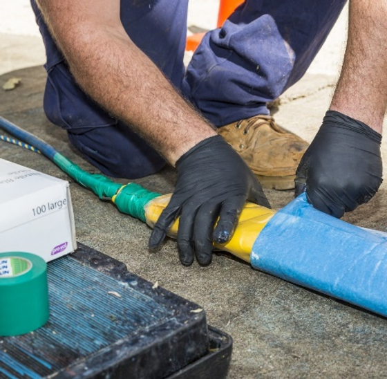Resin coated liner being inserted into a damaged sewer pipe for cured in place repair